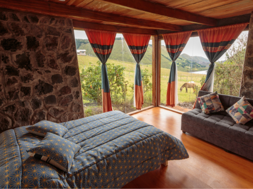 Room for two with private bath Cozy guest room at Tambo Cóndor with queen bed, warm bedding, and private bath in the Ecuadorian Andes.