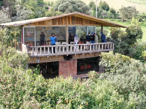 Tambo Condor Lodge An early picture of Tambo Condor Lodge, people standing on the back patio looking out over newly planted native trees